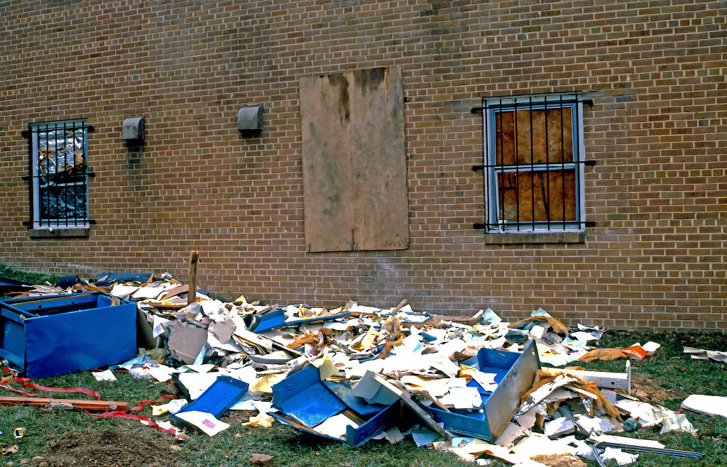 Debris and shattered glass can be seen on the lawn outside the boarded up window where the explosive device was placed Washington DC