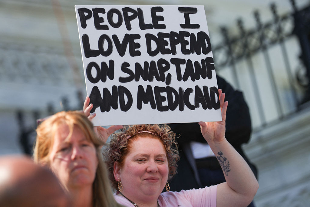 A demonstrator holds a sign during a sit-in protest