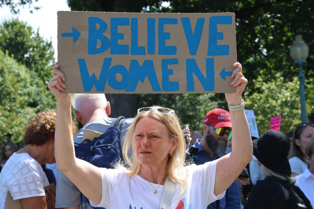 A supporter holds a “Believe Women” sign at a Sept. 3 rally outside the U.S. Capitol